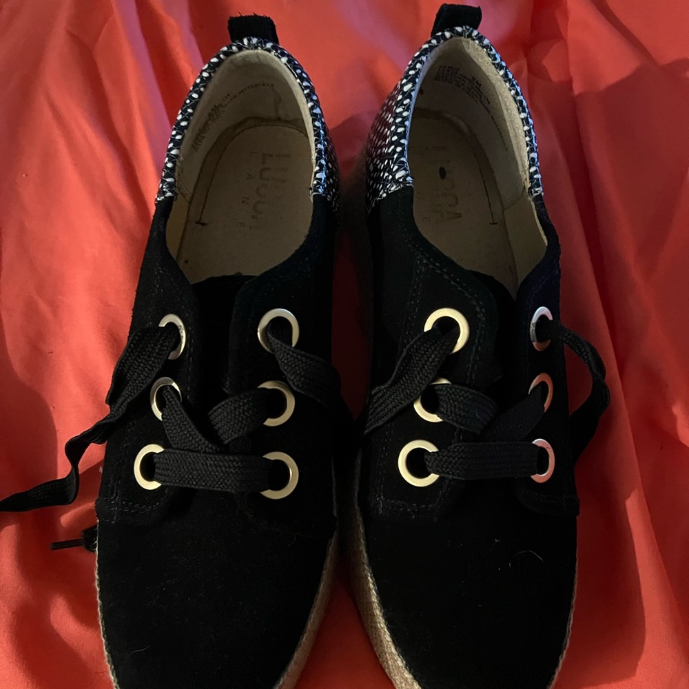 Black canvas shoes with black and white on heel